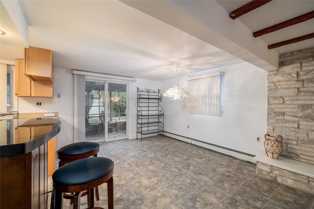 interior space featuring a chandelier, beam ceiling, and a baseboard heating unit