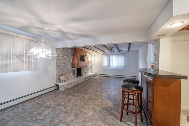 living room with lofted ceiling with beams, a fireplace, a baseboard radiator, and ceiling fan with notable chandelier