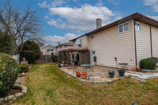 back of house with central AC, a yard, and a patio