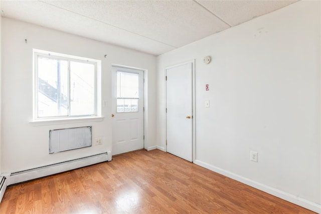 interior space featuring light hardwood / wood-style flooring and baseboard heating