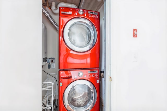 clothes washing area with stacked washer and clothes dryer