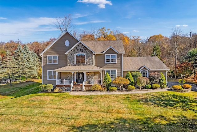 view of front of home featuring covered porch and a front lawn