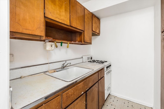 kitchen with sink and white range