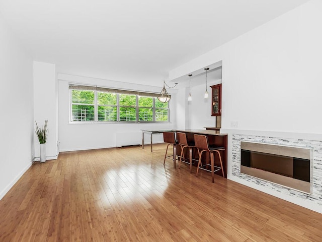 living room with light hardwood / wood-style flooring and indoor bar