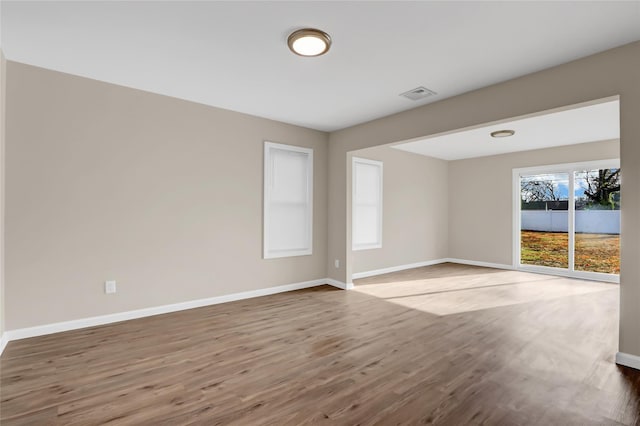 spare room featuring wood-type flooring