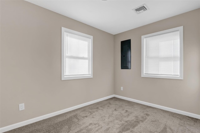 empty room with light carpet and electric panel