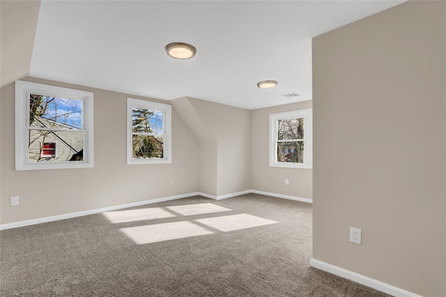 bonus room featuring carpet flooring and lofted ceiling