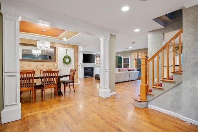 dining space featuring light hardwood / wood-style floors and an inviting chandelier