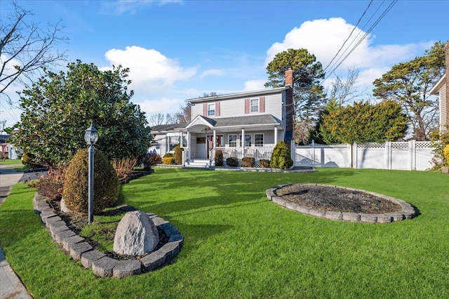 view of front of property with covered porch and a front yard