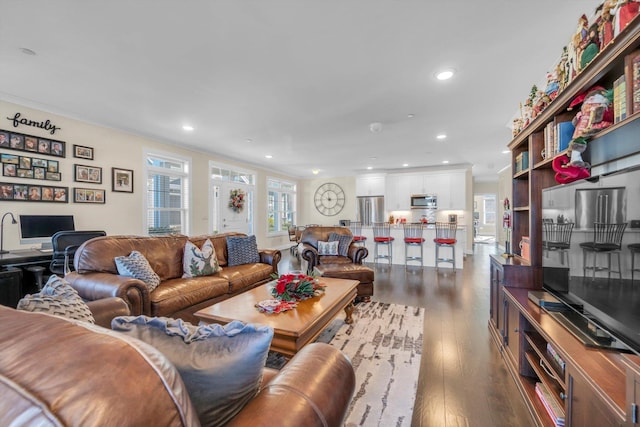 living room featuring dark hardwood / wood-style floors and crown molding