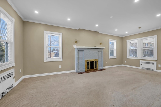 unfurnished living room with a fireplace, radiator heating unit, light colored carpet, and ornamental molding