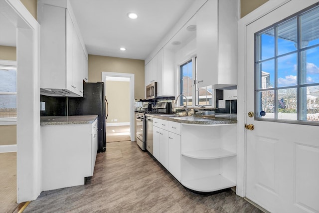 kitchen with white cabinetry, sink, and appliances with stainless steel finishes