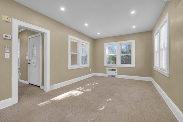 carpeted empty room featuring radiator