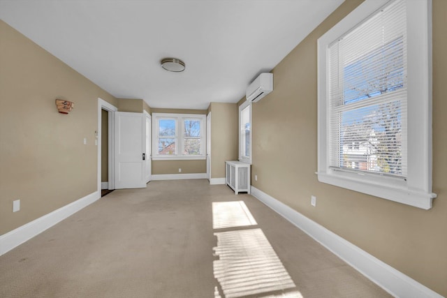 carpeted empty room featuring an AC wall unit and radiator