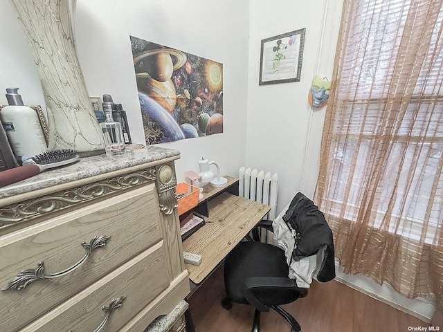 office with radiator and hardwood / wood-style floors