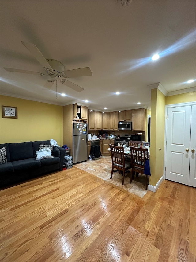 dining room featuring crown molding, ceiling fan, and light hardwood / wood-style floors