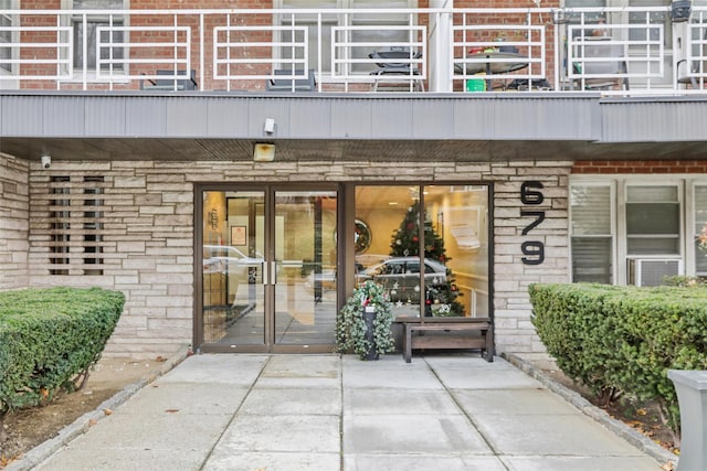 entrance to property featuring a patio area and a balcony