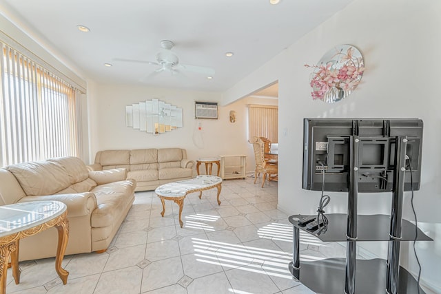 tiled living room featuring a wall unit AC and ceiling fan