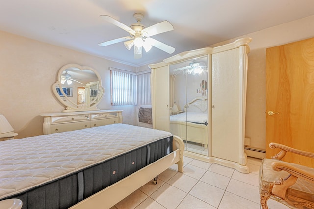 bedroom featuring ceiling fan, light tile patterned flooring, and a baseboard heating unit