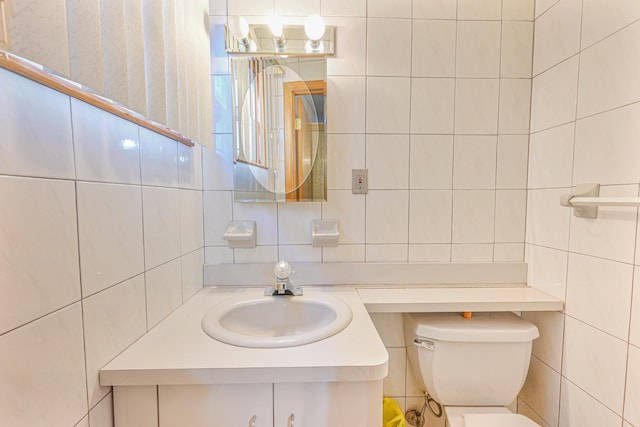 bathroom featuring backsplash, vanity, toilet, and tile walls