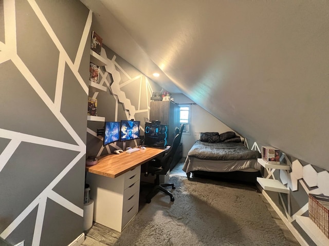 bedroom with carpet floors and vaulted ceiling