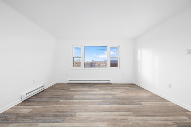 empty room featuring hardwood / wood-style floors and a baseboard radiator