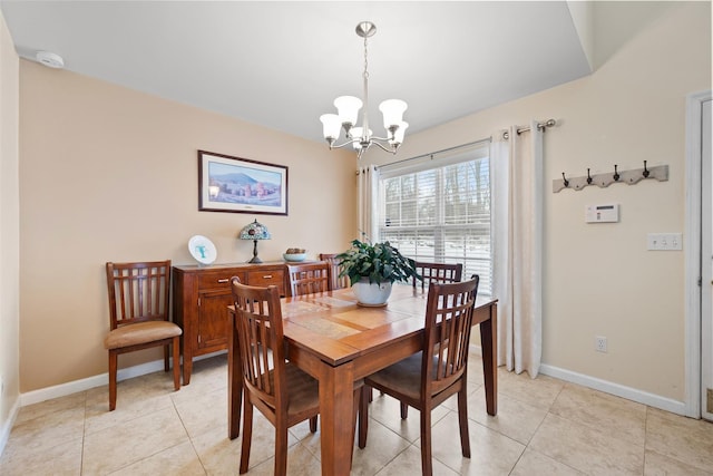 dining area with a chandelier and light tile patterned floors