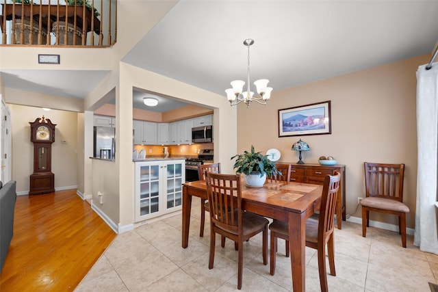 dining room featuring light tile patterned floors and a notable chandelier