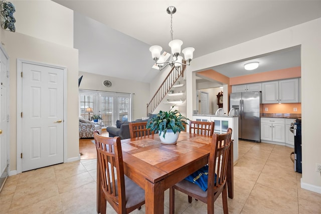 dining area featuring light tile patterned flooring and a notable chandelier