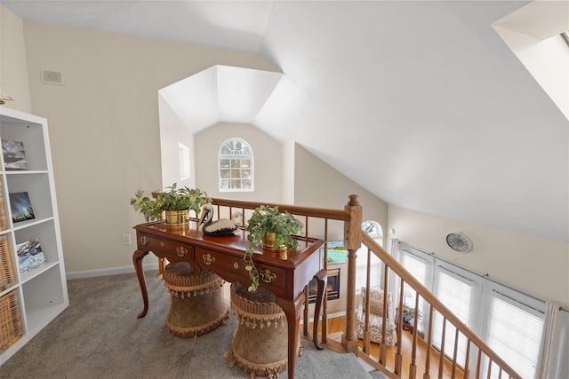 carpeted office space featuring lofted ceiling