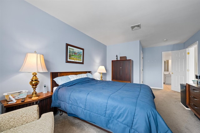 carpeted bedroom with ensuite bathroom