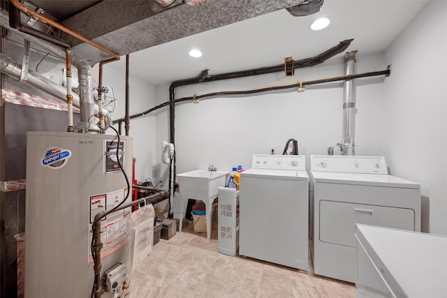 washroom with independent washer and dryer and water heater