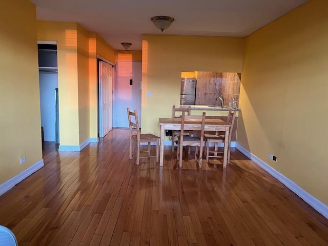 dining room featuring hardwood / wood-style flooring and sink