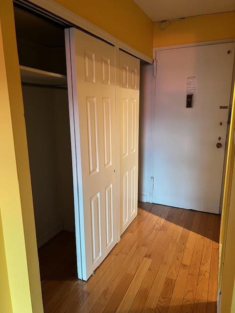 corridor with hardwood / wood-style floors