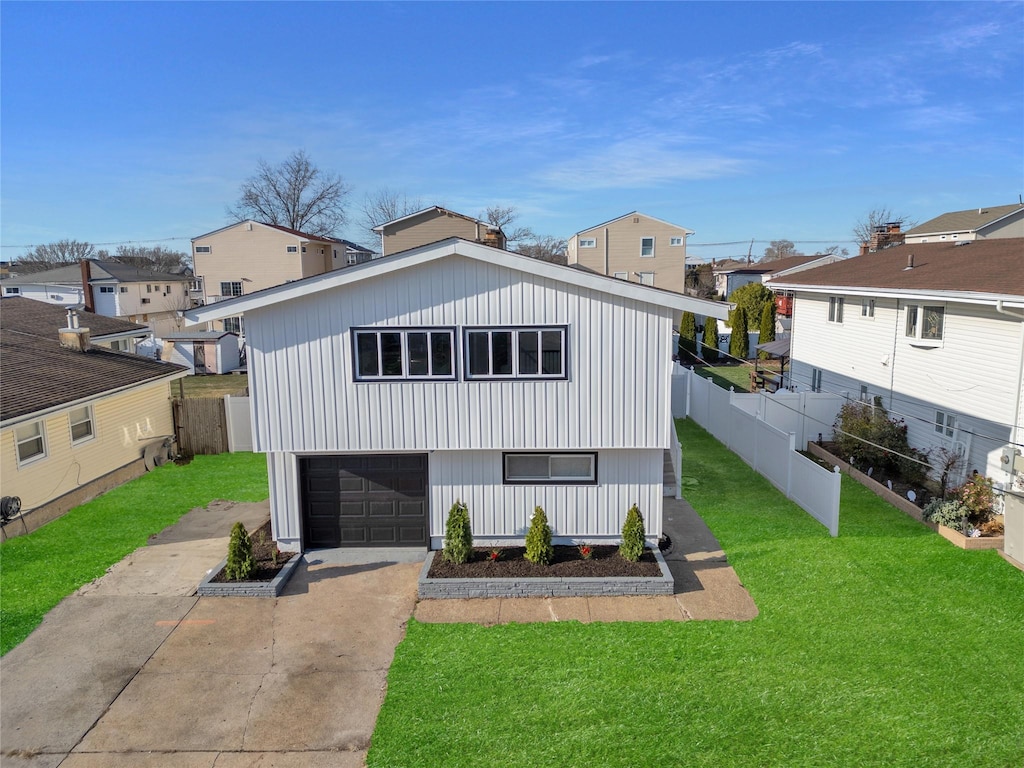 view of front facade with a garage and a front lawn