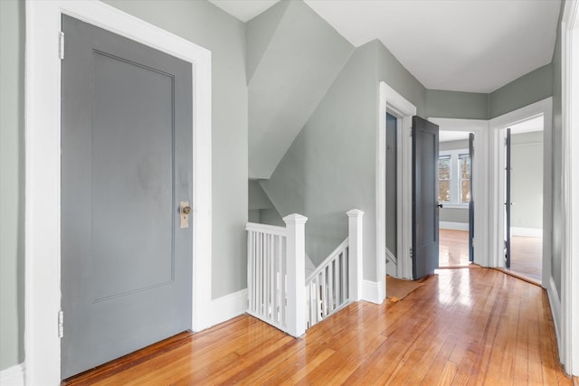 hall with hardwood / wood-style flooring