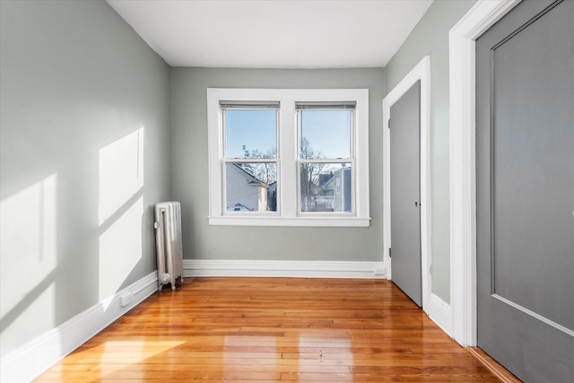 empty room with radiator and light hardwood / wood-style floors