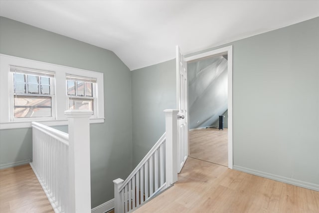 hall featuring vaulted ceiling and light wood-type flooring