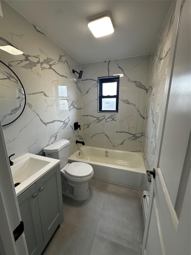 full bathroom with a baseboard heating unit, toilet, vanity, tile walls, and tiled shower / bath