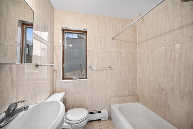 bathroom with tile patterned floors, sink, baseboard heating, and tile walls