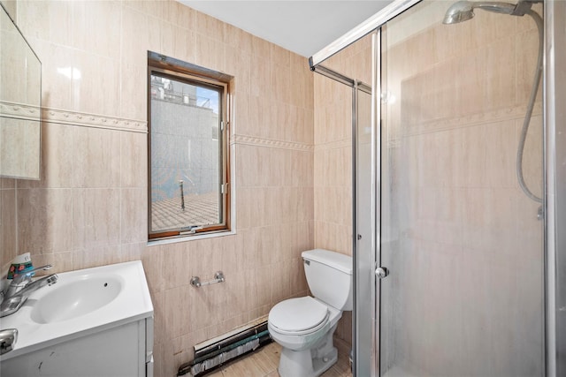 bathroom featuring vanity, toilet, a shower with shower door, and tile walls