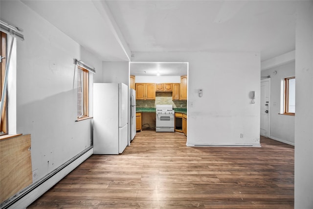 kitchen featuring white appliances, a baseboard radiator, light brown cabinetry, light wood-style floors, and tasteful backsplash