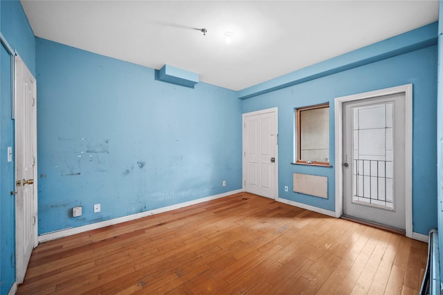 unfurnished bedroom featuring baseboards and hardwood / wood-style flooring