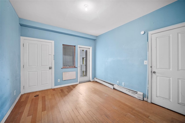 interior space with wood finished floors, baseboards, and baseboard heating