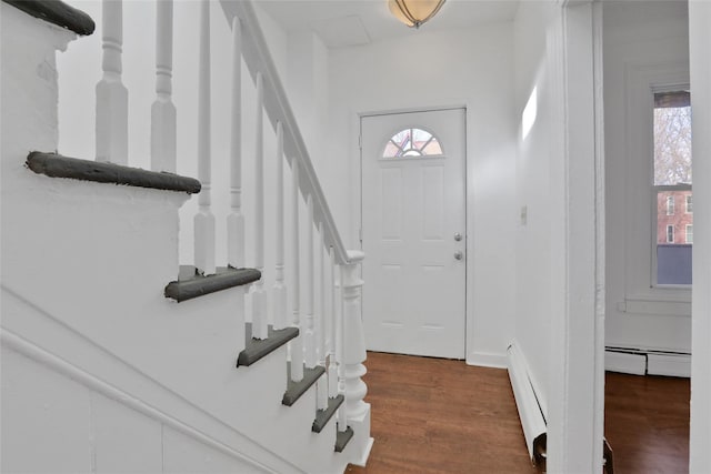 foyer entrance featuring dark hardwood / wood-style floors and a baseboard radiator