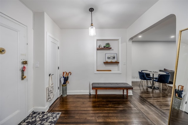 entryway with dark hardwood / wood-style flooring