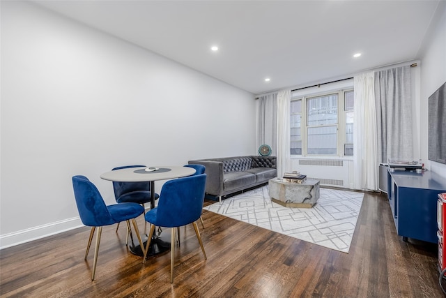 interior space with dark hardwood / wood-style flooring and radiator heating unit