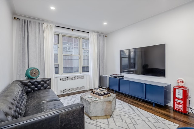 living room with radiator heating unit and hardwood / wood-style flooring