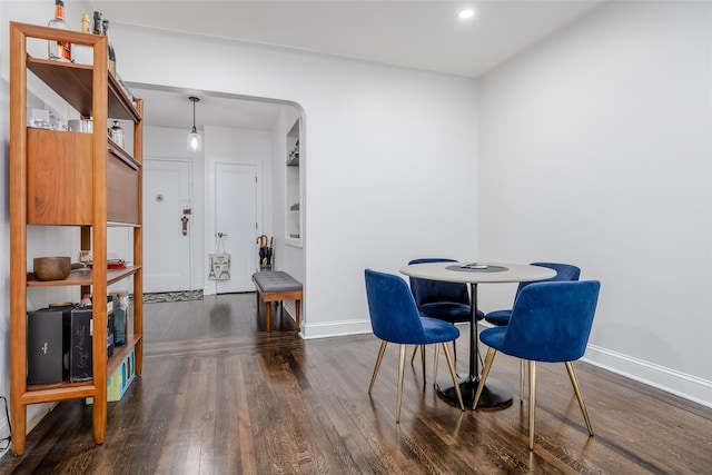 dining room with dark hardwood / wood-style flooring