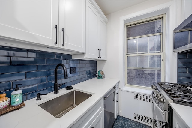 kitchen with tasteful backsplash, white cabinetry, sink, and stainless steel appliances